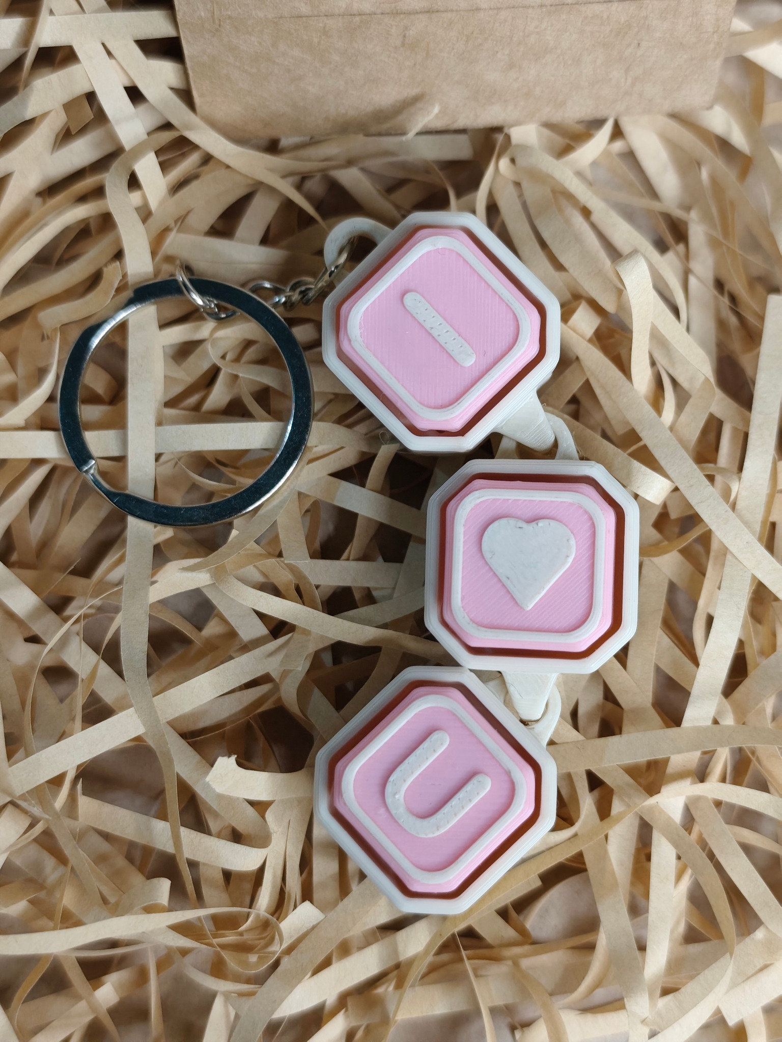 Llavero clicker articulado rosa y blanco